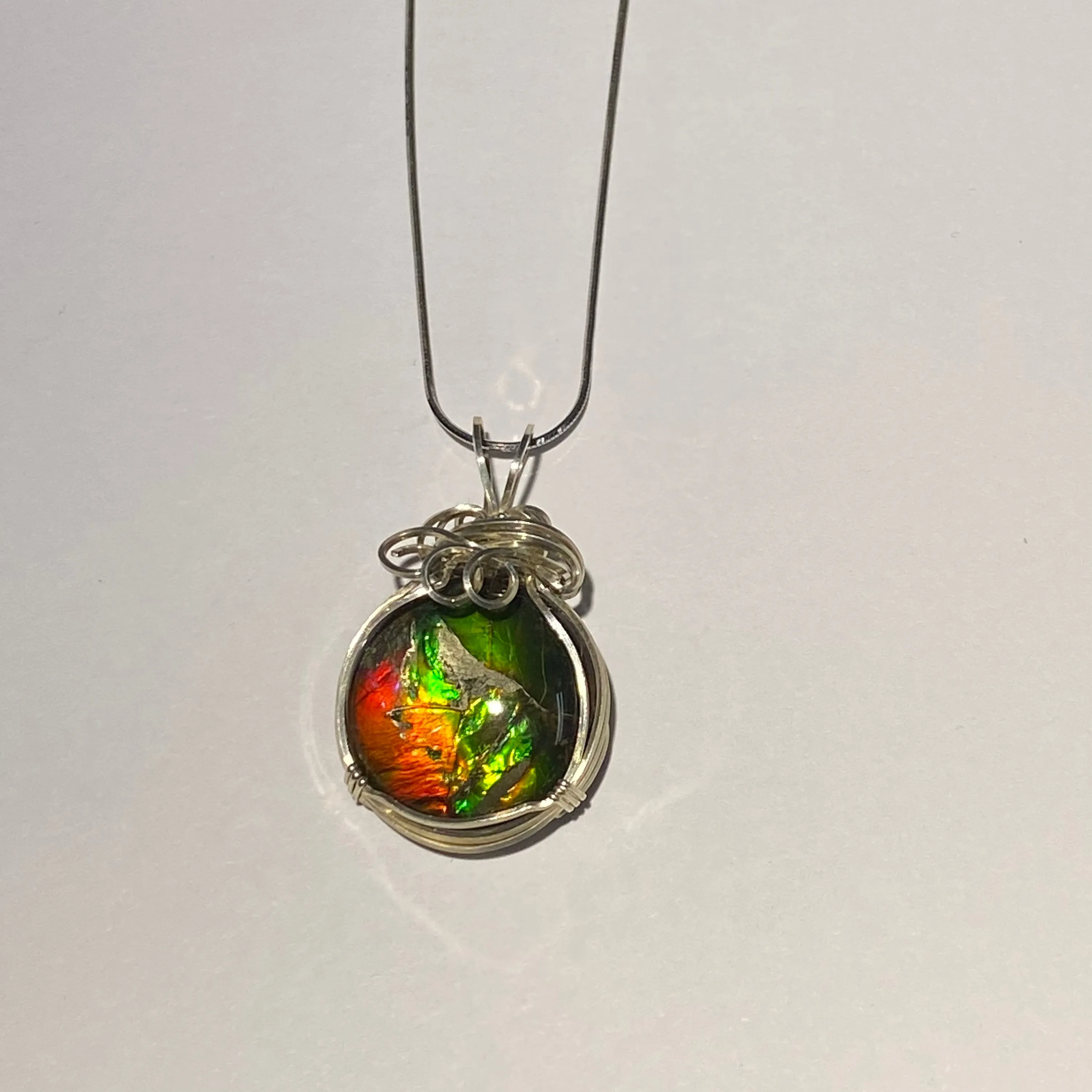 Ammolite pendant amazing colours, Sterling Silver wire wrap