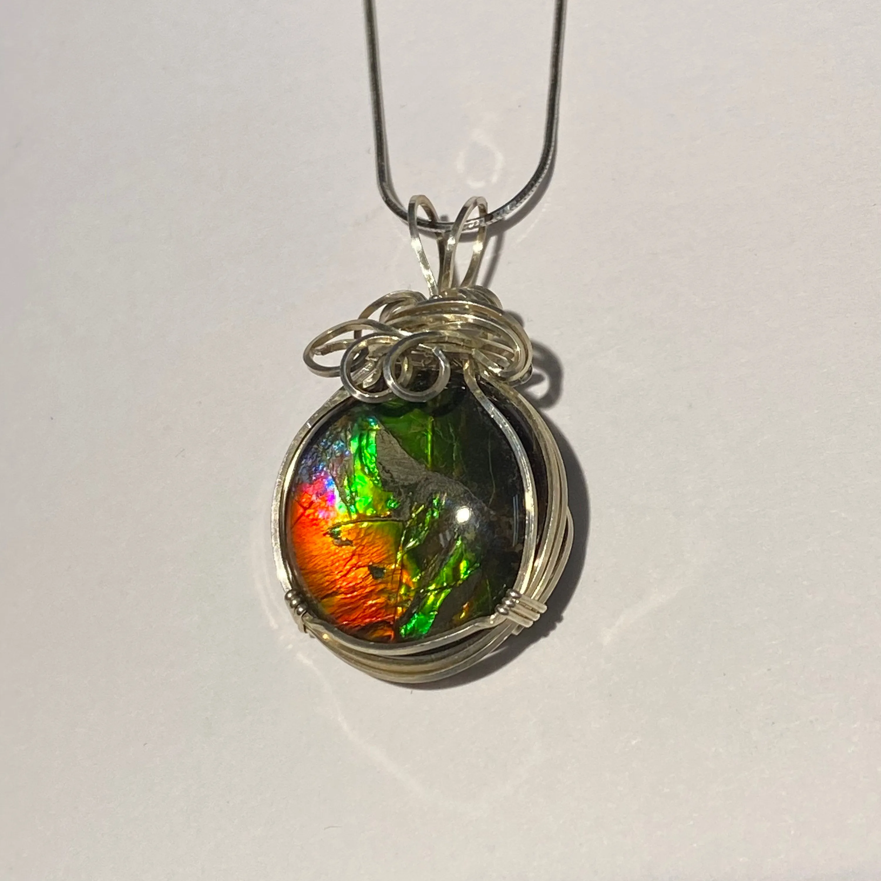Ammolite pendant amazing colours, Sterling Silver wire wrap